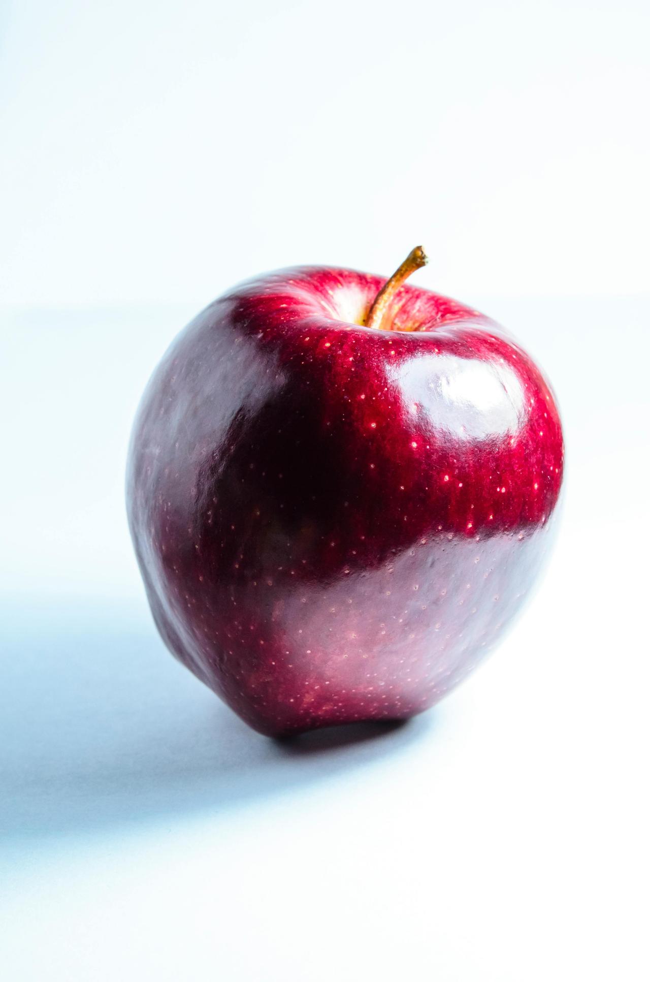 A single red apple on a white background